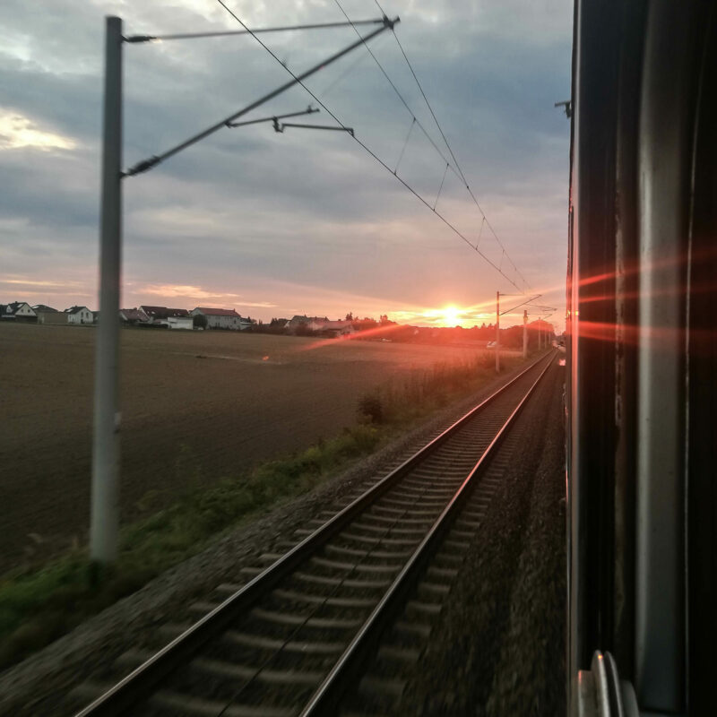 Das Bild zeigt einen Sonnenuntergang auf der Rückreise aus dem Zug fotografiert.